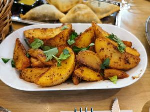 Batata harra (spinach dumplings in the background). at Levant Grill in Falkoping