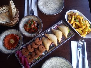 Vegan Mezze for two people: Aubergines with walnut-filling, muhammara (walnut parika dip), falafel, fried potatoes with garlic, spinach pouches, libanese bread (came with the meal) at Levant Grill in Falkoping