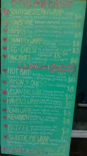 A picture of part of the Sissy's outdoor menu showing breakfast wraps and sandwiches in sections for breakfast and lunch. Picture taken March 2021. at Sissy's Cafe in Kingston