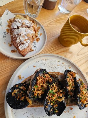 Mushroom on Sourdough, almond croissant and (an almost finished) oat Latte 🥰 at Faun in Malvern