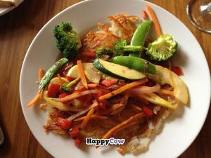 Breakfast hash: sauteed veggies over hash browns over tofu scramble.  at Om Cafe - Traverse City in Traverse City