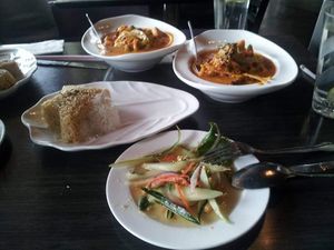 Pumpkin curry, spicy noodles, brown+white rice, summer salad at Plumeria in San Diego
