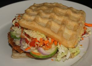 Vegan Waffles Sandwich.  Gluten free waffle made with cornmeal, chickpea patty, and salad filling.  at Highland in Bohol