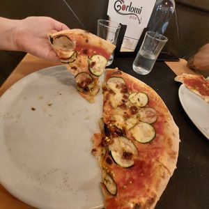 Esta es una foto de la Michella con mozarella vegana. Salsa de tomate, calabacín, tomate seco y pistacho que se añade después de ser horneada at Gorlomi Pizza in Pontevedra