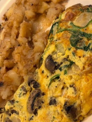 Omelette with mushrooms, onion, & spinach + vegan cheese. Very generous amount of mushrooms. Potatoes were cooked to perfection. Absolutely fantastic! at The Local's Spot in Egg Harbor