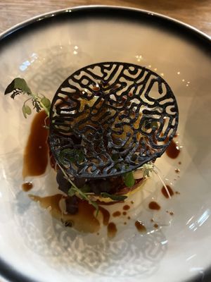 Vegan starter with scallop of celeriac and jackfruit as a substitute for the sea bass, with apple, soy and black beans  at De Brass Goes in Goes