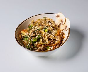 Vegan vok: wheat udon noodles, bell pepper, green onion, red onion, mushrooms, soy sauce at TUF Club in Yerevan