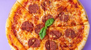 Vegan pepperoni pizza: yeast dough, pizza sauce, vegan cheese, tomatoes, vegan semi-smoked sausage at Fibonacci in Almaty