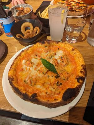 The vegan lasagne pizza with onion rings on the side at Nonna Said in Glasgow