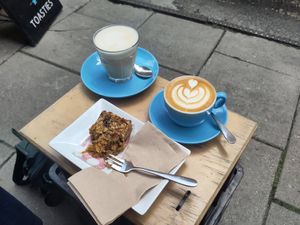 Oat milk chai latte and flat white with a flapjack. at Small Street Espresso in Bristol