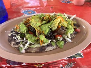 My huarache with all veggies, beans, and zucchini flower .  at Antojitos Oaxaqueños Dona Martha in Oaxaca