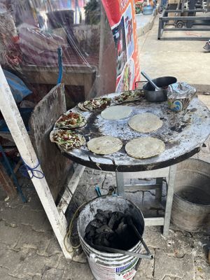 I don’t know whose food they were cooking at the time of the photo, but everything is cooked on this grill.   at Antojitos Oaxaqueños Dona Martha in Oaxaca