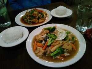 Tofu and veggies with light garlic sauce in the front, tofu with basil leaves in the back.  at Bua Thai Cuisine in Washington