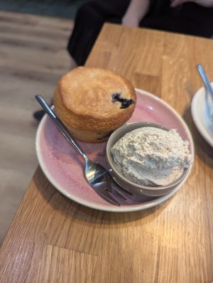 Blueberry muffin with extra cream at Velo Cafe & Bar in Interlaken