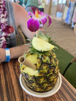 a mango vegan drink in a pineapple.   at Polynesian Cultural Center in Laiea
