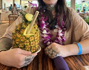  a mango vegan drink in a pineapple.   at Polynesian Cultural Center in Laiea