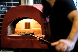 Watch a skilled chef prepare a wood-fired-style vegetarian pizza in a traditional oven. Get ready to savor the authentic Italian flavors at Papa G's Pizzeria! at Papa G's Pizzeria in Blacktown