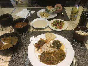 Vegetarian menu with curries, served with bread, tahini, salad and rice and falafel burger (got 2 small but cute burgers).  at Sunflower Restaurant in Luxor