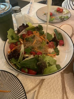 Glass noodle salad with spicy lime 🍋‍🟩🥗🍅dressing on a bed of lettuce.   at Vegan Plate in Chicago