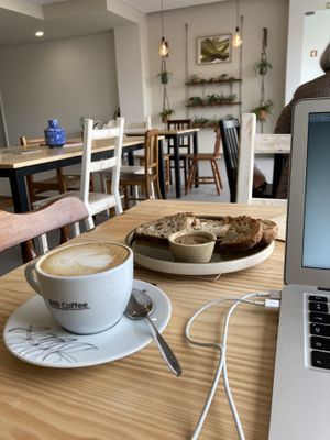 Cappuccino com bebida vegetal e tosta de pão de figos com manteiga de frutos secos.  at Lume Agricultura e Padaria Bio in Santa Maria Da Feira