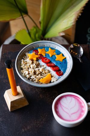 Blue ocean smoothie bowl, topped with homemade rawnola and served with a shot of jamu and our beetroot latte. at Living Food Lab Canggu in Canggu