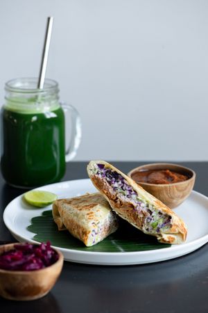 Barbecue jackfruit wrap, served with extra sauce and sauerkraut. at Living Food Lab Canggu in Canggu