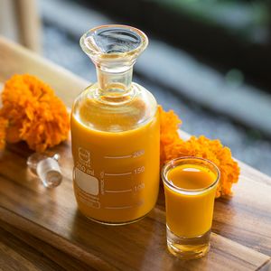 LFL Jamu shots  of turmeric, lime and orange juice, and coconut palm nectar at Living Food Lab Canggu in Canggu