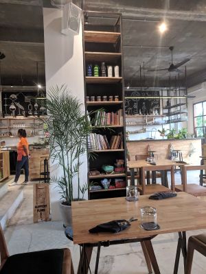 Shelf with books and games at Living Food Lab Canggu in Canggu