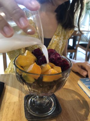 Granola bowl with Mango, dragon fruit and coconut milk at Living Food Lab Canggu in Canggu