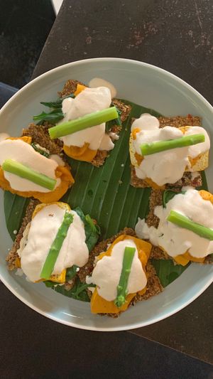 tofu benedict on raw, gf crackers at Living Food Lab Canggu in Canggu