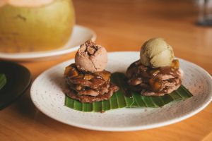 Pancakes with cinnamon-apple compote and raisin sauce, one pile with chocolate ice cream and the other with matcha ice cream. 

Photo credit to the beautiful @ohmychayka on IG at Living Food Lab Canggu in Canggu