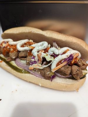 BUFFALO "CHICKEN": chopped chik’n, pickles, red onion, coleslaw, cheddar sauce, kemperature buffalo sauce, house made ranch at Frondescence in Boise