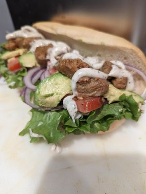 CHICKEN AVOCADO RANCH: Chopped chik’n, Green leaf lettuce, pickle,  red onion, organic tomato, provolone, avocado, house made ranch  at Frondescence in Boise