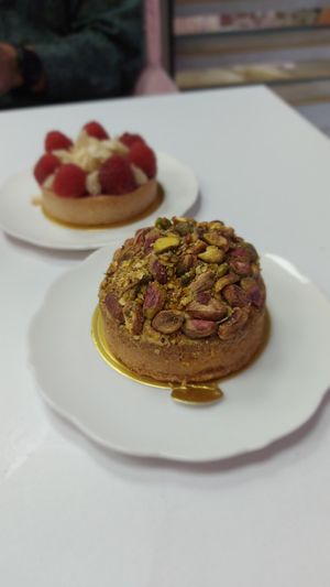 Pistachio cake, with raspberry marzipan in the background at Cream Dream in London