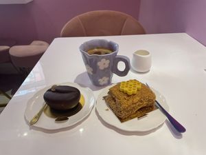 Vegan chocolate & caramel pastry and Ukrainian honey cake. Americano with oat milk on the side   at Cream Dream in London