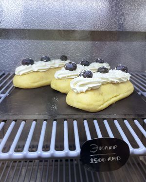 Vegan eclair with cream, whipped cream and blueberries at Letters and Numbers in Yerevan