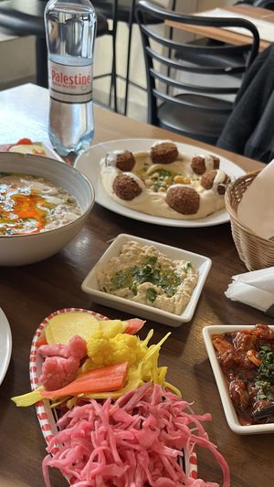 foul mdamas, hummus falafel, baba ganoush, pickled vegetables  at Palestinian Restaurant - Spalena in Prague