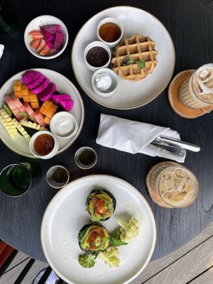 Fruit, waffles, tofu Benedict, iced lattes  at Tangi Restaurant in Ubud