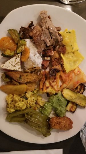 A full plate including ravioli,  gnocchi, seitan, risotto and much more! at Ops Cucina Mediterranea in Rome