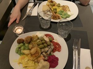 Mix of items including lasagne, gnocchi, ravioli, olives, hummus, potatoes, rice based dishes and vegan mayo at Ops Cucina Mediterranea in Rome