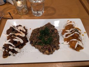 Risotto with sides of roasted eggplant and pumpkin.  The eggplant and pumpkin are drizzled with oat yogurt.  Delicious! at Afghan Bistro in Springfield