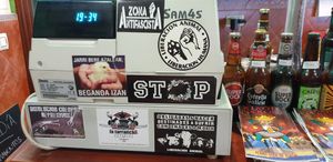 Interesting vegan stickers on the till at Puzzle Bar in Gijon
