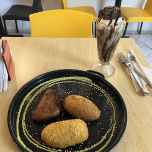 A special they had of 3 empanadas with different fillings including vegan cheese and chorizo served with fries (not pictured) and a brownie milkshakee  at ChapiYork in Bogota