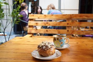 Almond custard & espresso glaze donut (8GEL) with an americano (8GEL) in the back. Outdoor seating is made of palettes, but there’s nice small tables indoors. at Stricha in Tbilisi