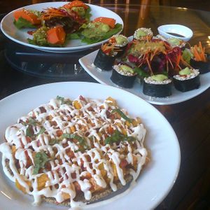 Hawaiin pizza, barley sushi and papaya with guacamole in lettuce cups at Rasayana Raw Healthy Deli in Bangkok
