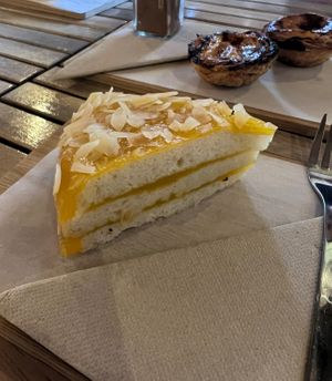 Vegan cake and NON VEGAN Pasteis de Natas in the background  at Gato Legal Coffee Roastery in Ponta Do Pargo