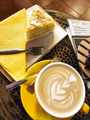 Oat milk cappuccino and a vegan cake at Gato Legal Coffee Roastery in Ponta Do Pargo