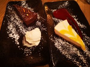 Chocolate and clementine torte with ice cream, and lemon cheesecake with berry coulis at Reishi Plant Kitchen in Worcester