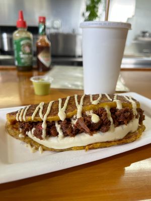 Queso & Jack Cachapa. Mechada Jackfruit, Cashew Cheeze in a folded Sweet Corn Pancake (cachapa) topped with Cashew Cream. at Pacha Roots in Miami