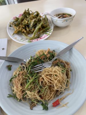 Fried noodles accompanied by deep friend morning glory with dipping sauce.   at Sutunthip Vegetarian Food in Bangkok